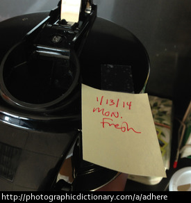 Photo of a post-it note stuck to a coffee machine