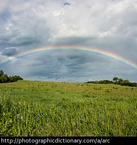 A rainbow in the shape of an arc.