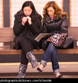 Photo of two women sitting beside each other.