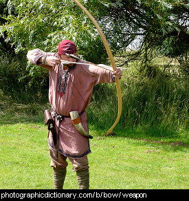 Photo of a man drawing a bow