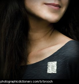 Photo of a woman wearing a silver brooch