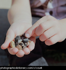 Photo of a child counting pebbles