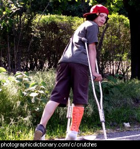 Photo of a boy on crutches ... and a skateboard