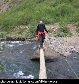 Photo of a man crossing a dangerous bridge