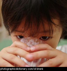 Photo of a child drinking a glass of water