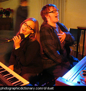 Photo of two people singing a duet