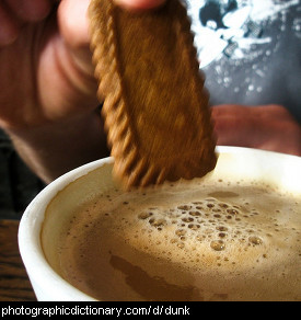 Photo of someone dunking a cookie into coffee