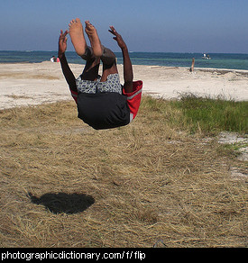 Photo of a boy doing a backflip