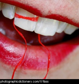 Photo of a girl flossing her teeth