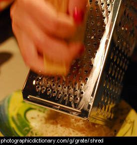 Photo of someone grating cheese.