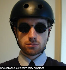 Photo of a man wearing a black helmet.