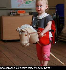 Photo of a toddler riding a hobby horse