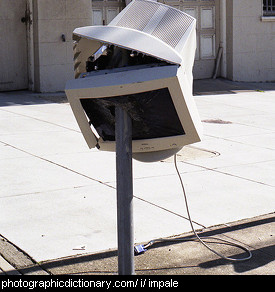 Photo of a monitor impaled on a post