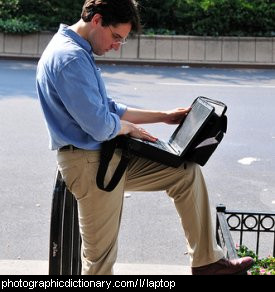 Photo of a man using a laptop