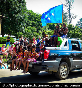 A man waving the flag of Micronesia.