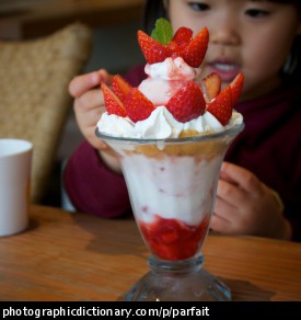 Photo of a little girl eating parfait.