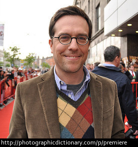 Actor Ed Helms standing on the red carpet at a movie premiere.