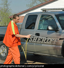 Photo of a prison inmate washing a car