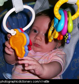 Photo of a baby and some hanging rattles
