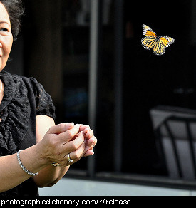 Photo of a woman releasing a butterfly