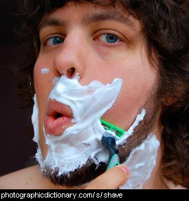 Photo of a man shaving his face
