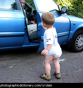 Photo of a child slamming a car door