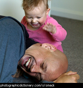 Photo of a little girl smacking her father