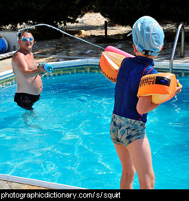 Photo of a child squirting their parent with a water gun