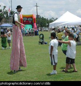 Photo of a man wearing stilts