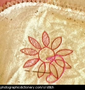 Photo of a flower being stitched to some fabric