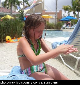 Photo of a girl applying sunscreen