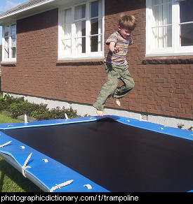 Photo of a boy jumping on a trampoline