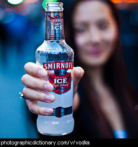Photo of a woman holding a bottle of vodka