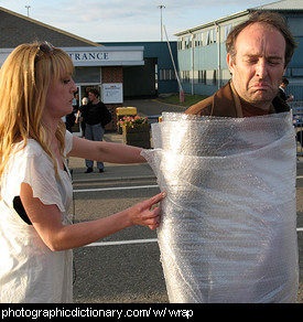 Photo of a man being wrapped up.