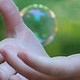 Photo of child's hands and a bubble