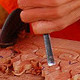 Photo of a man carving wood
