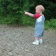 Photo of a child pointing left.