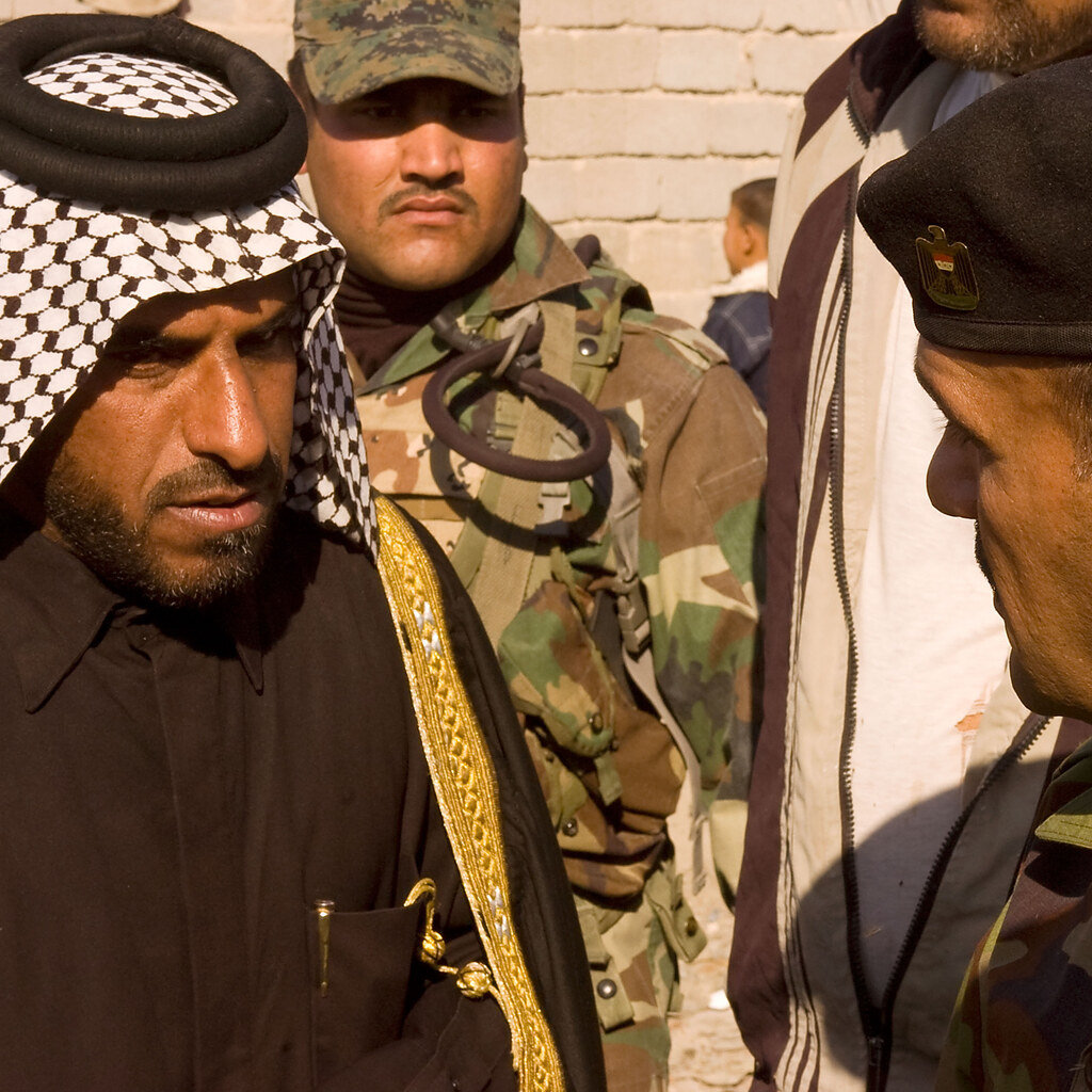 Photo of men talking.
