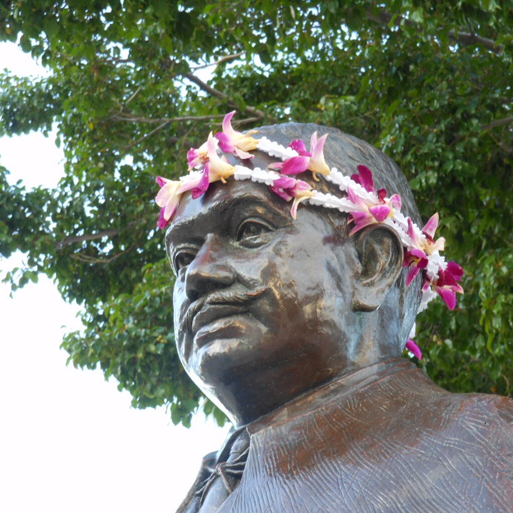 A statue adorned with flowers.