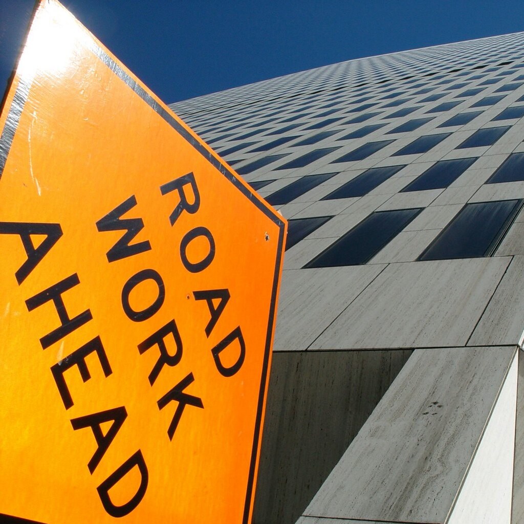 Photo of a road sign that says road work ahead