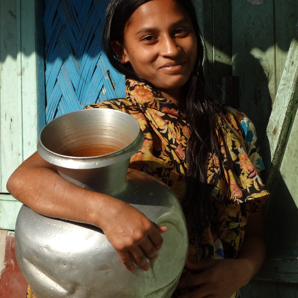 Photo of a woman with a water jug