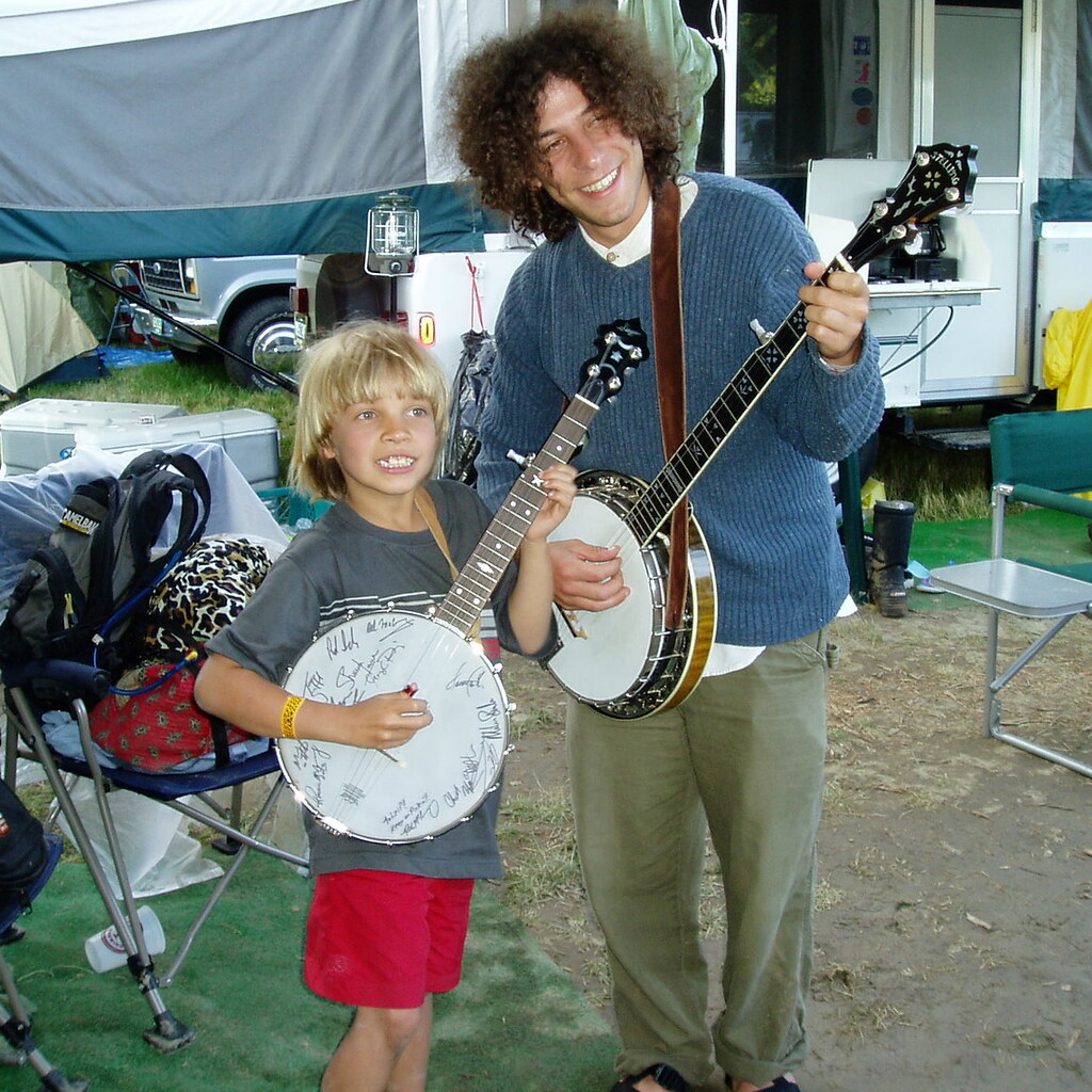 Photo of two people playing banjos
