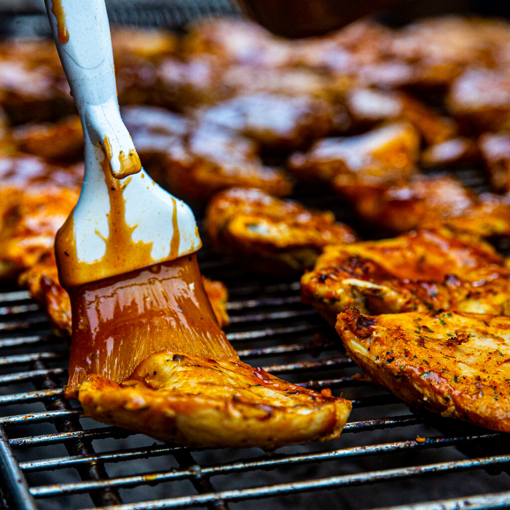 Photo of someone basting meat