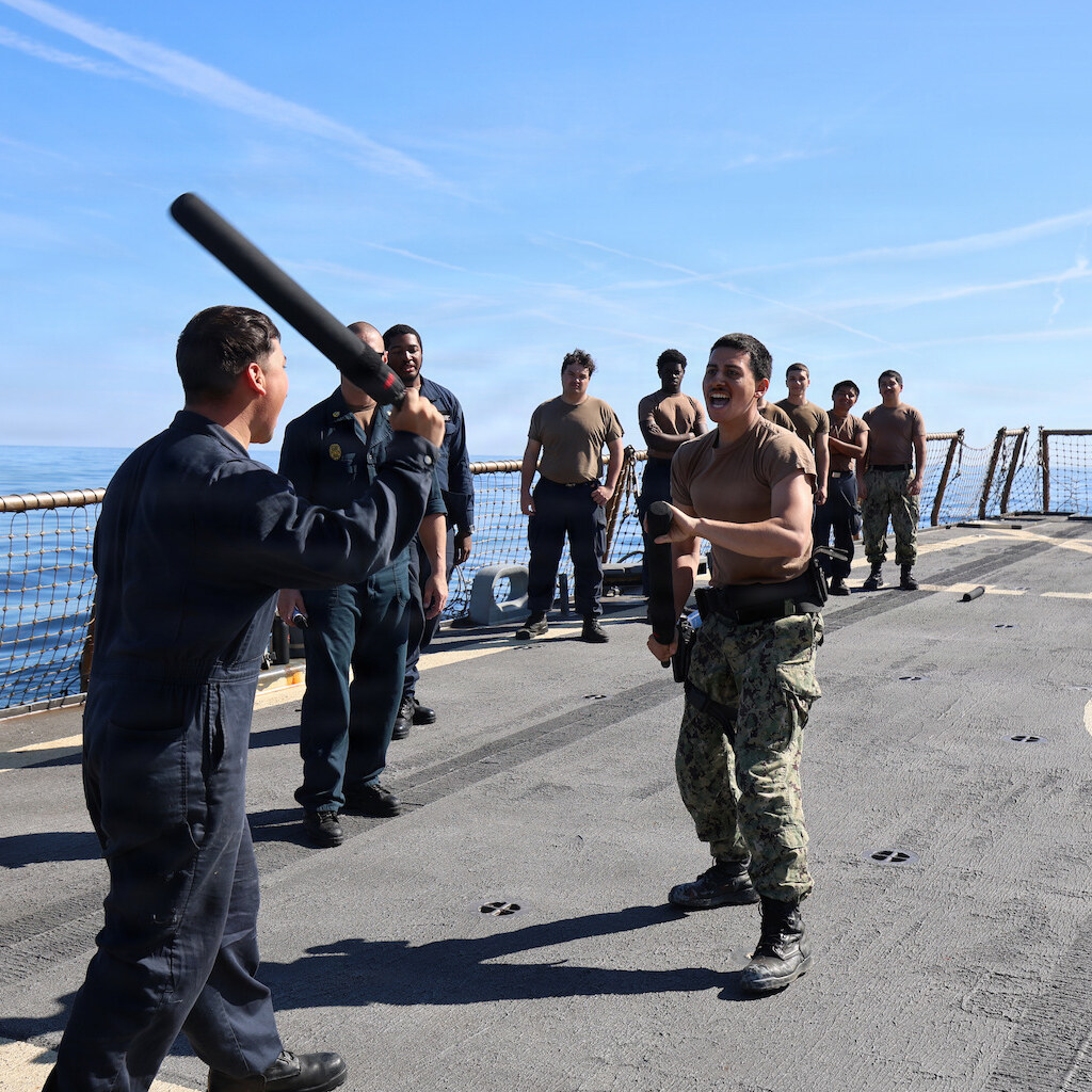 Photo of sailors fighting with batons