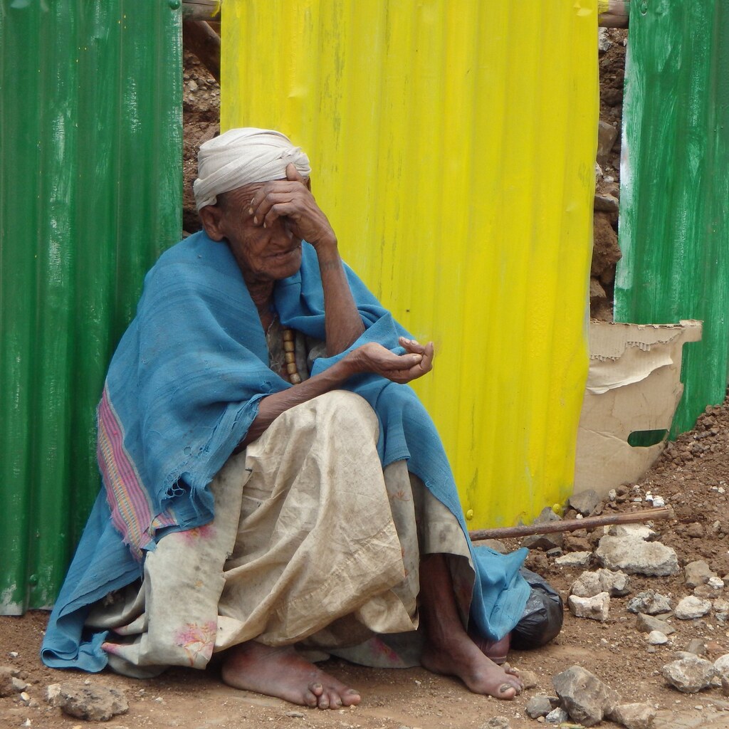 Photo of a man begging.
