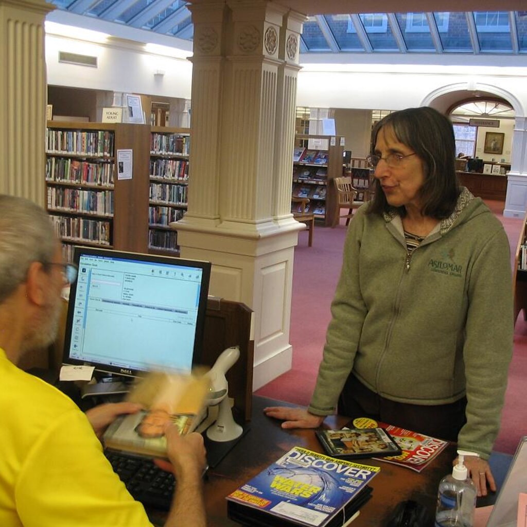 Photo of a woman borrowing some books