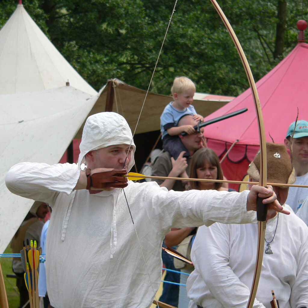 Photo of a man drawing a bow