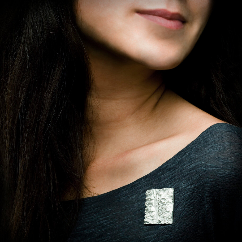 Photo of a woman wearing a silver brooch