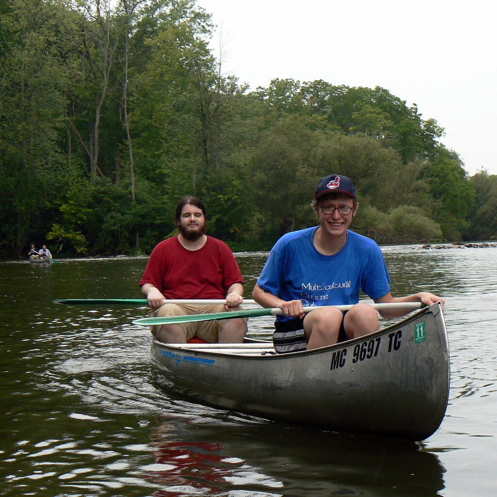 Photo of two men paddling a canoe