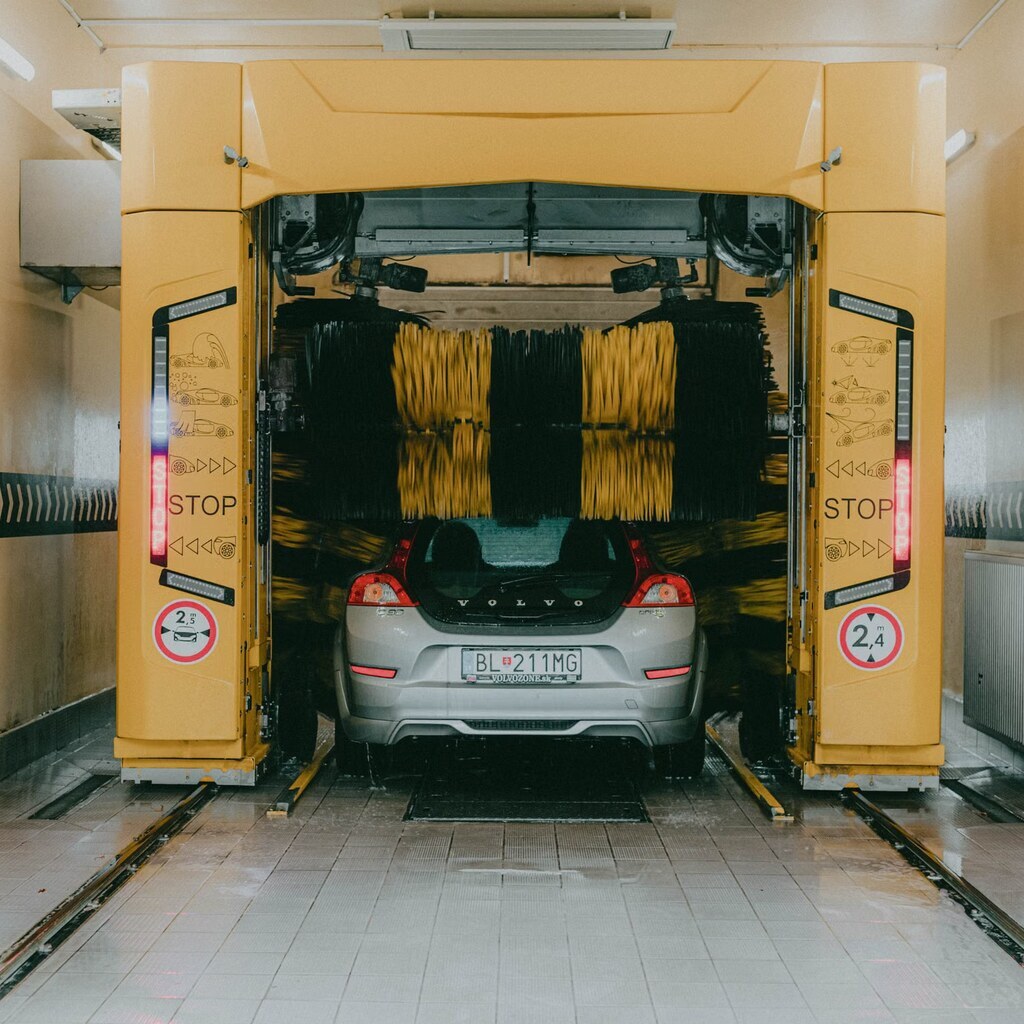 A photo of a car passing through an automatic carwash.